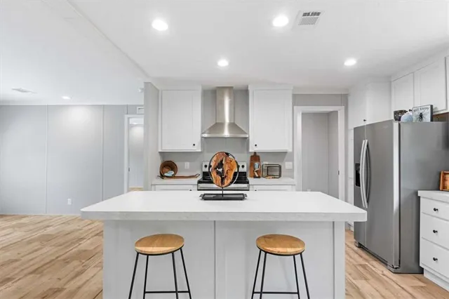 a view of a dining room with furniture and a refrigerator
