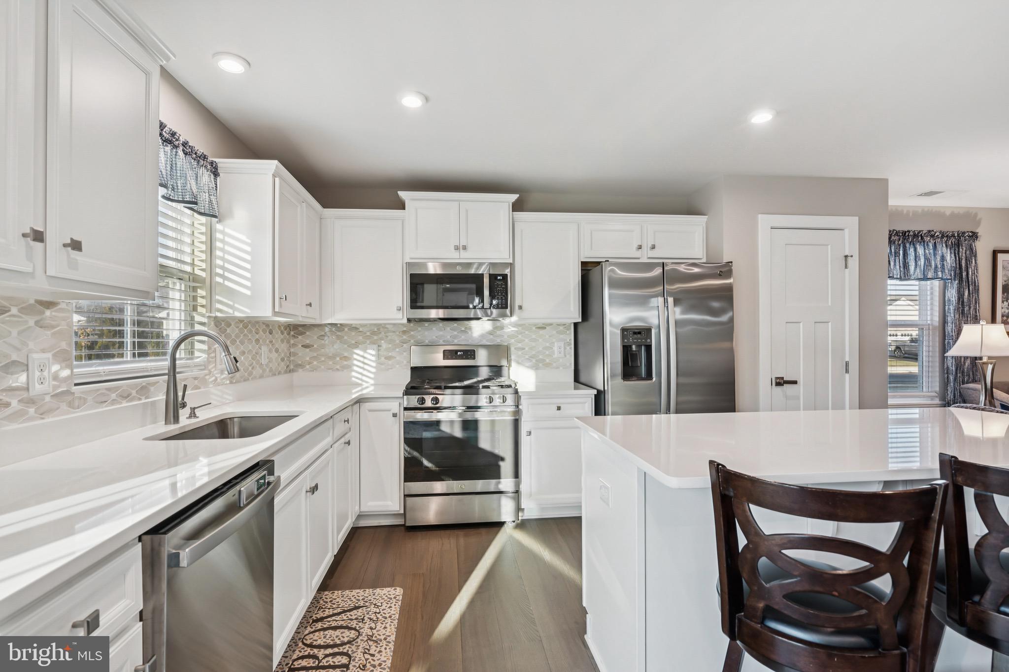 15 Truman Road Berlin, NJ 08009 - Photo 11 of 24 a kitchen with a sink a stove a microwave and cabinets
