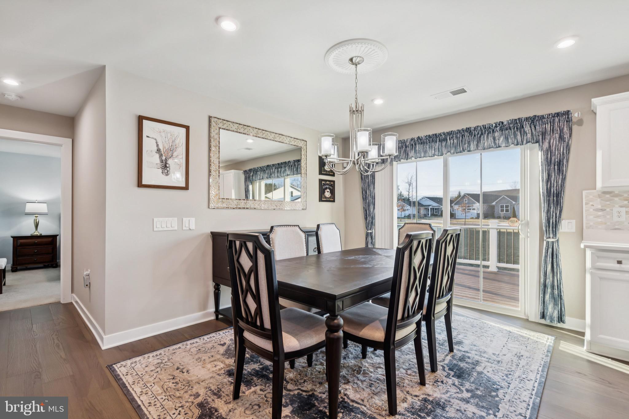 15 Truman Road Berlin, NJ 08009 - Photo 8 of 24 a dining room with furniture a chandelier and wooden floor