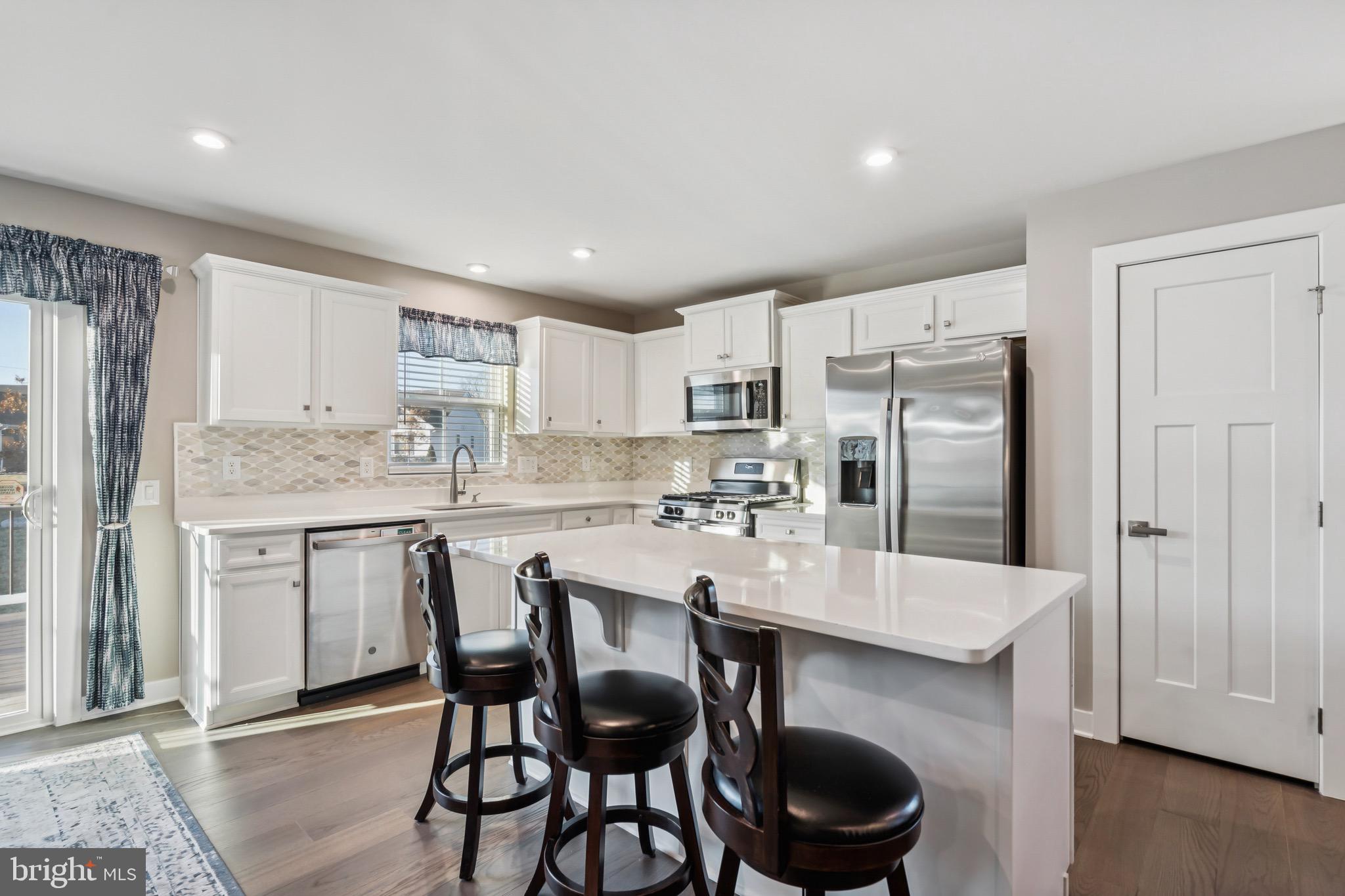 15 Truman Road Berlin, NJ 08009 - Photo 10 of 24 a kitchen with a dining table chairs and refrigerator