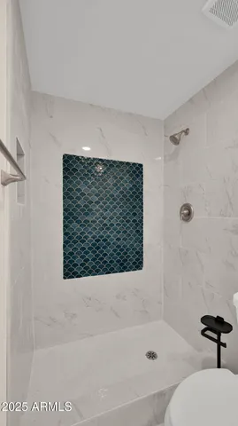 a bathroom with a bathtub and a shower