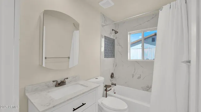a bathroom with a sink toilet tub and shower