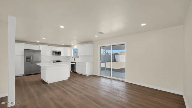 a view of a kitchen with wooden floor