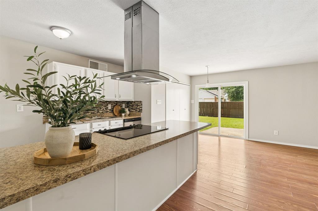5620 Perrin Street The Colony, TX 75056 - Photo 6 of 31 a kitchen with stainless steel appliances granite countertop a sink and a wooden floor
