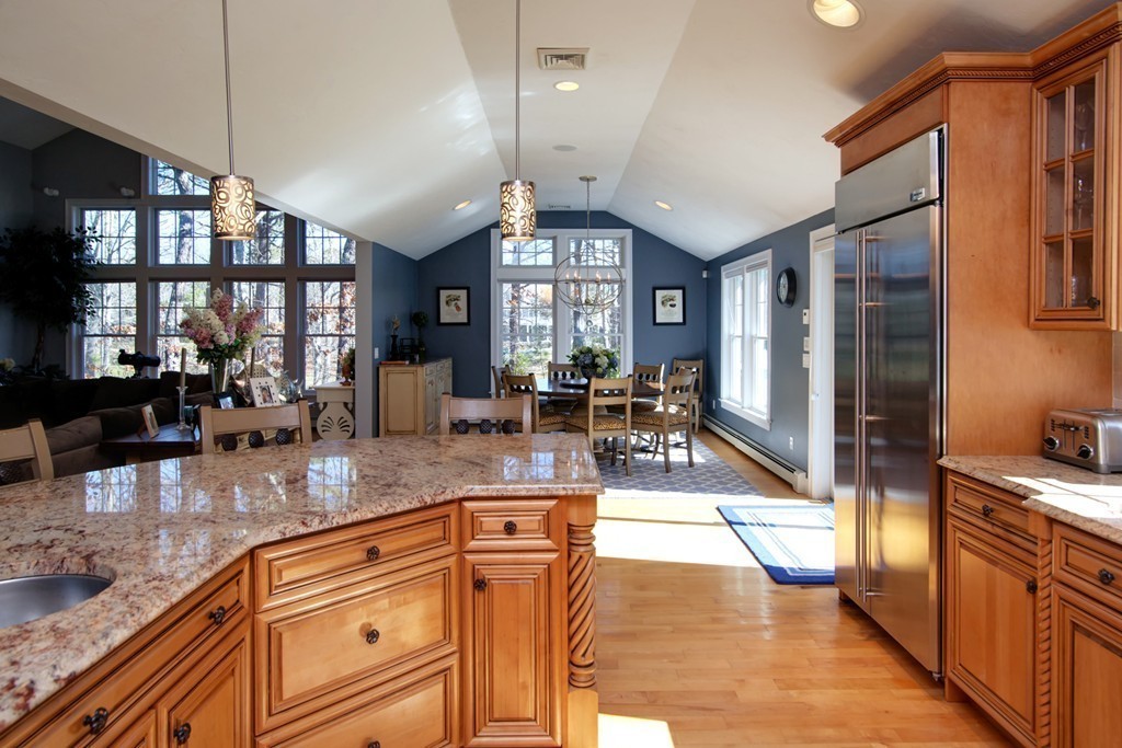 a kitchen with stainless steel appliances granite countertop a refrigerator a stove and a sink with granite countertops