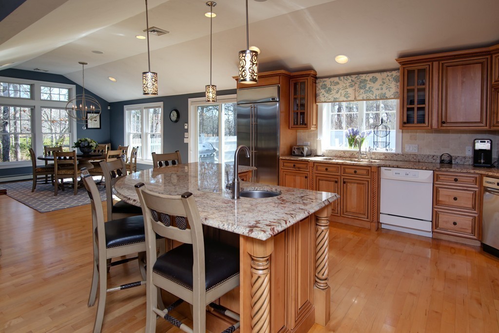 84 Troon Place Mashpee, MA 02649 - Photo 11 of 30 a kitchen with center island table and chairs in it