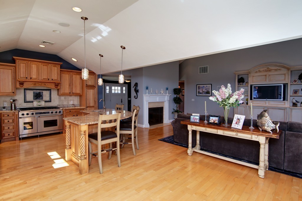 84 Troon Place Mashpee, MA 02649 - Photo 14 of 30 a view of a dining room with furniture a kitchen and chandelier