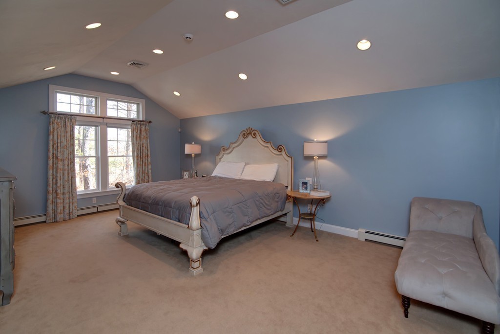 84 Troon Place Mashpee, MA 02649 - Photo 19 of 30 a spacious bedroom with a bed and a couch