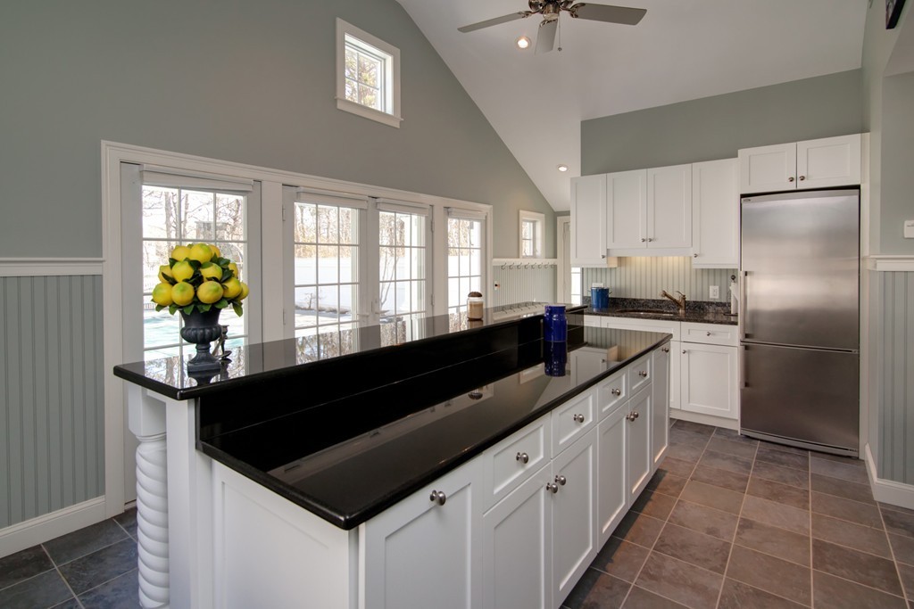 84 Troon Place Mashpee, MA 02649 - Photo 28 of 30 a kitchen with granite countertop a sink stainless steel appliances cabinets and a window