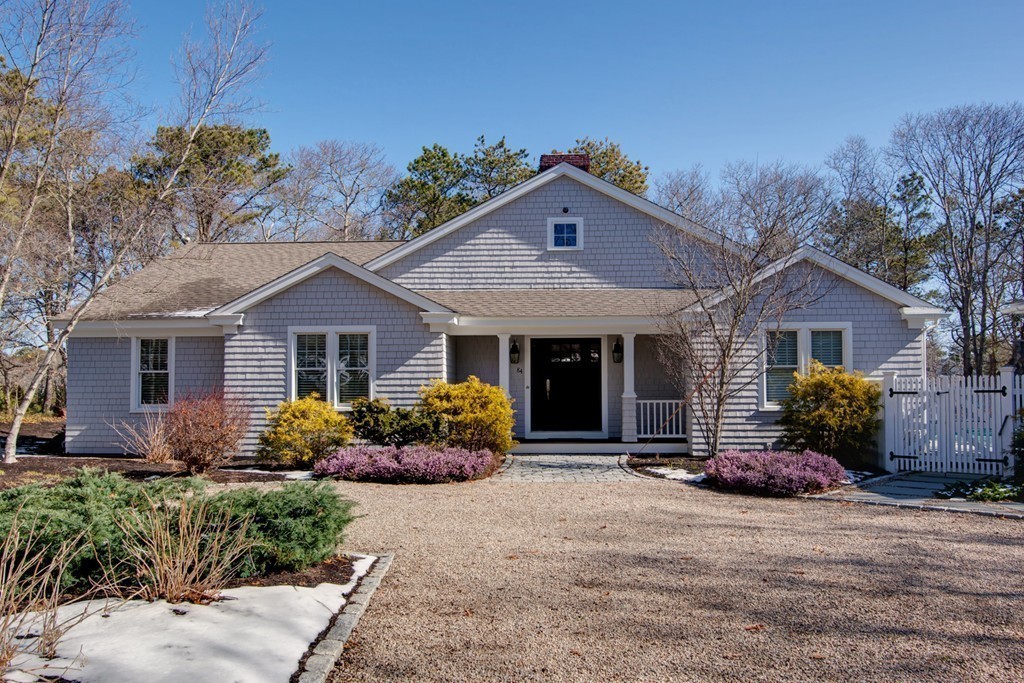 84 Troon Place Mashpee, MA 02649 - Photo 6 of 30 a front view of a house with a yard and potted plants