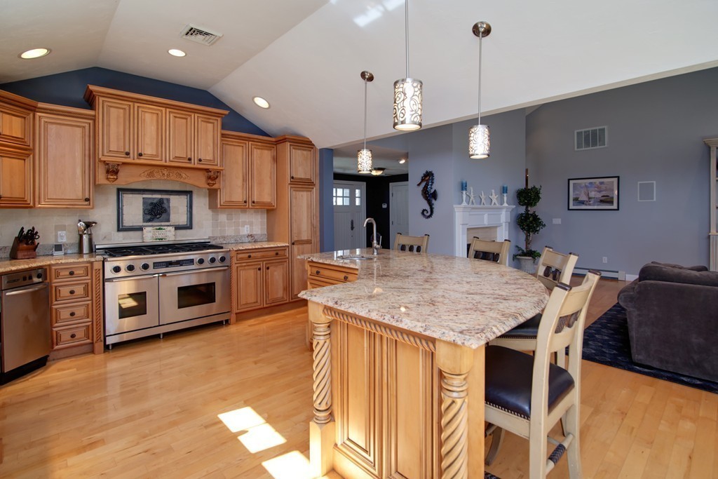 84 Troon Place Mashpee, MA 02649 - Photo 10 of 30 a kitchen with stainless steel appliances kitchen island granite countertop a stove top oven a sink a counter top space and cabinets