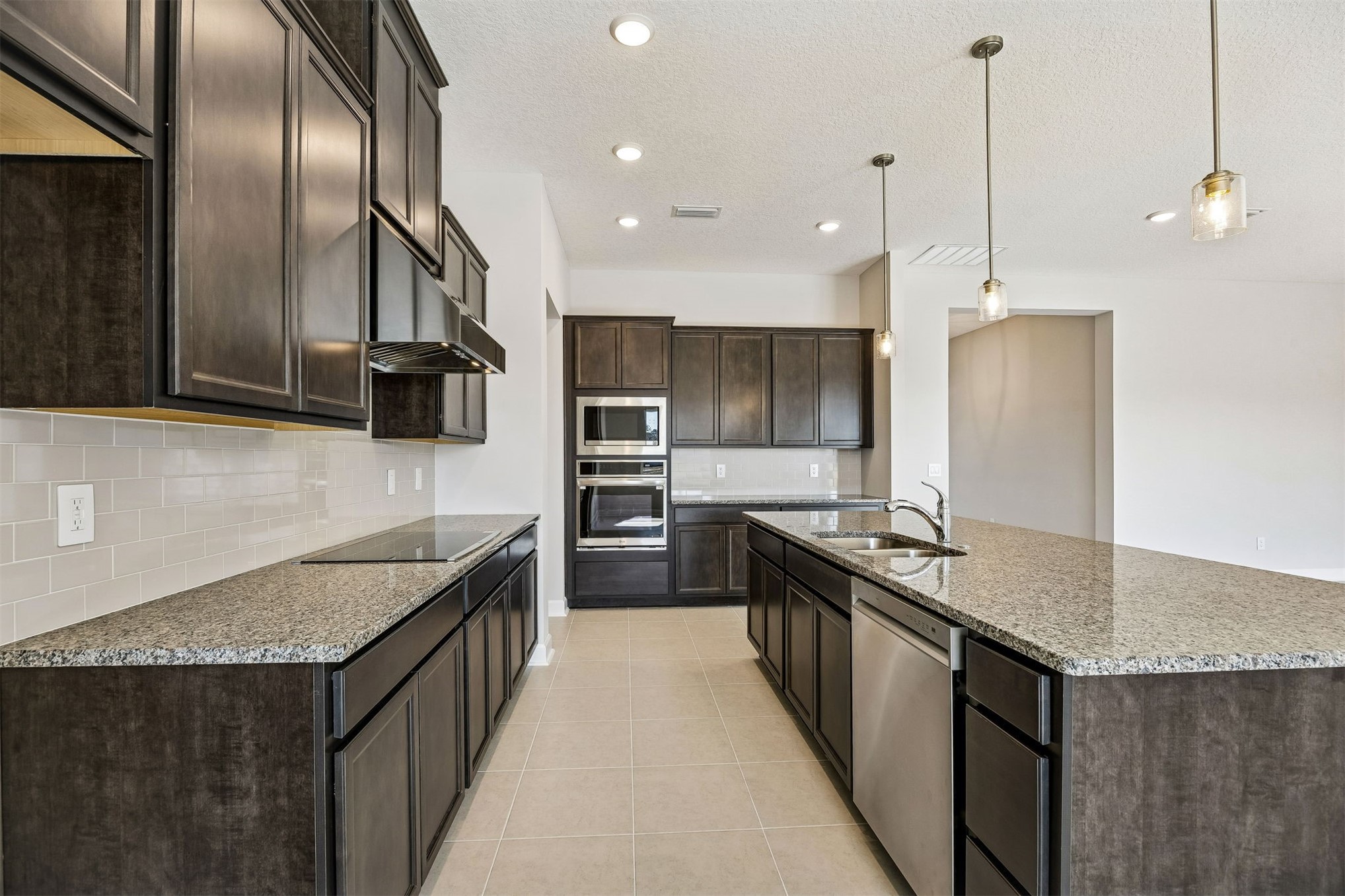 85417 Sandy Rdg Loop Yulee, FL 32097 - Photo 9 of 21 a kitchen with stainless steel appliances granite countertop a sink a stove and a wooden floors