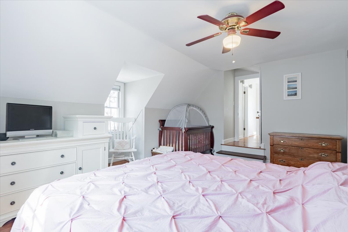 413 Grant Street Normal, IL 61761 - Photo 17 of 40 a bedroom with a large bed and a flat screen tv