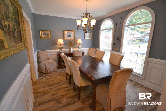 1640 Augusta Drive West Mobile, AL 36695 - Photo 14 of 25 Formal dining room is divine with custom wainscoting, crown molding, arched windows and new tile flooring.