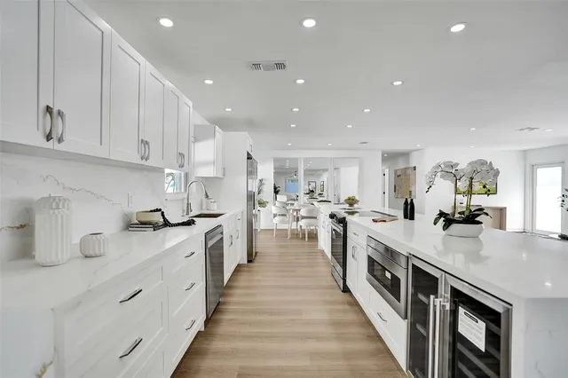 a kitchen with stainless steel appliances white cabinets and a granite counter tops