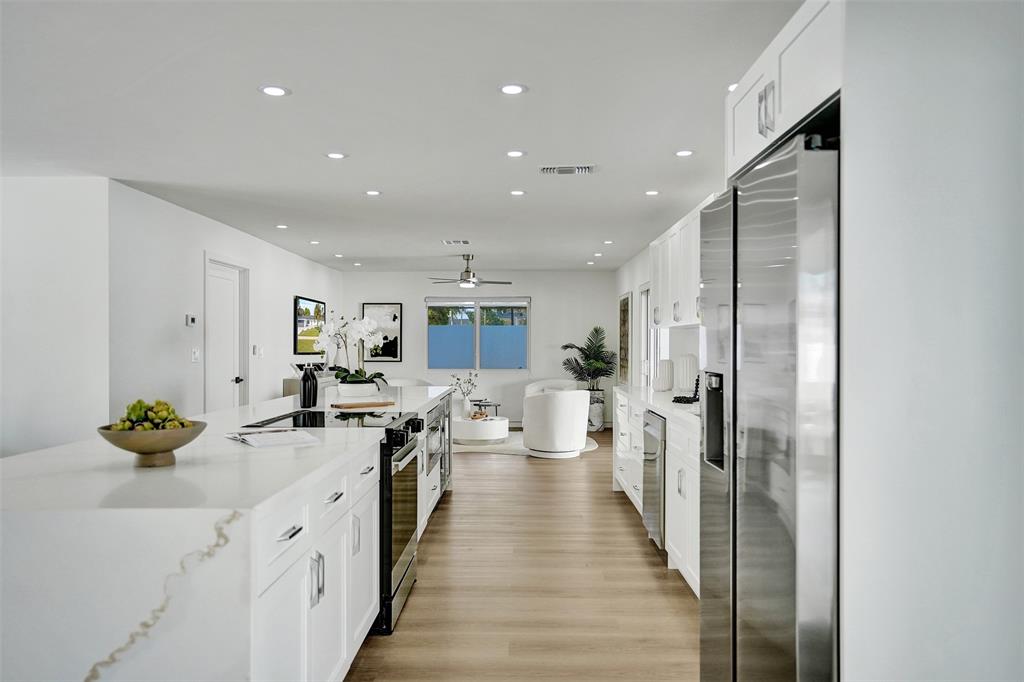 699 Northeast 70th Street Boca Raton, FL 33487 - Photo 15 of 60 a open kitchen with stainless steel appliances granite countertop a lot of counter space and wooden floor