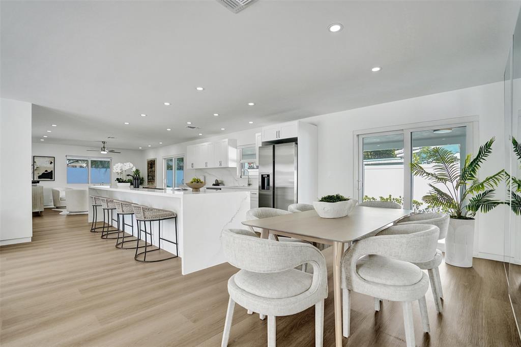 699 Northeast 70th Street Boca Raton, FL 33487 - Photo 21 of 60 a view of a dining room with furniture and wooden floor