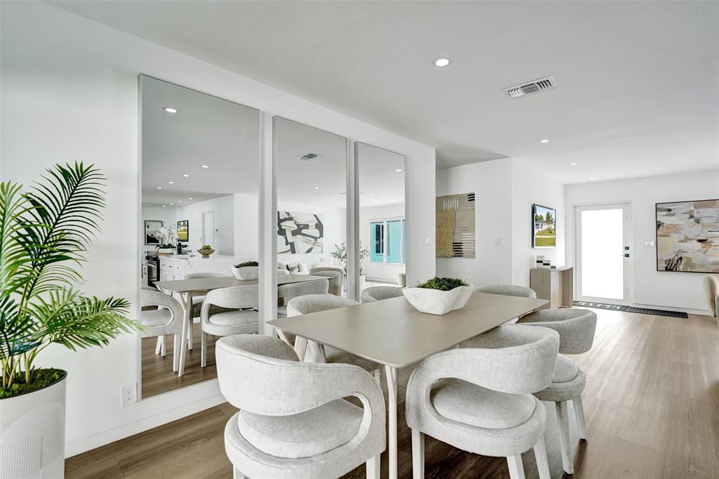 699 Northeast 70th Street Boca Raton, FL 33487 - Photo 22 of 60 a view of a dining room with furniture and wooden floor