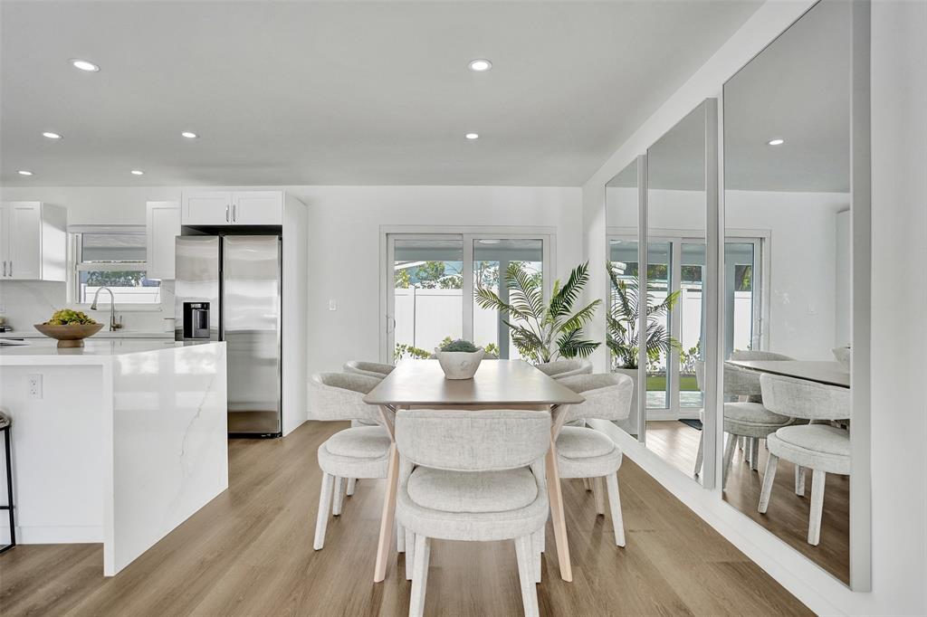 699 Northeast 70th Street Boca Raton, FL 33487 - Photo 23 of 60 a dining room with furniture and a large window