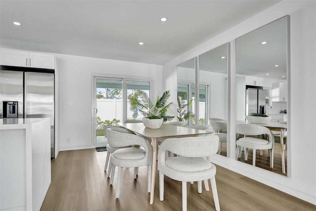 699 Northeast 70th Street Boca Raton, FL 33487 - Photo 24 of 60 a dining room with furniture and wooden floor