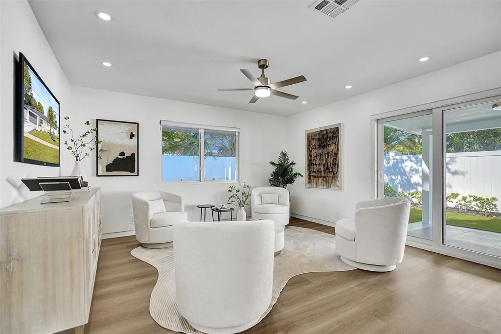 699 Northeast 70th Street Boca Raton, FL 33487 - Photo 26 of 60 a living room with furniture and a flat screen tv