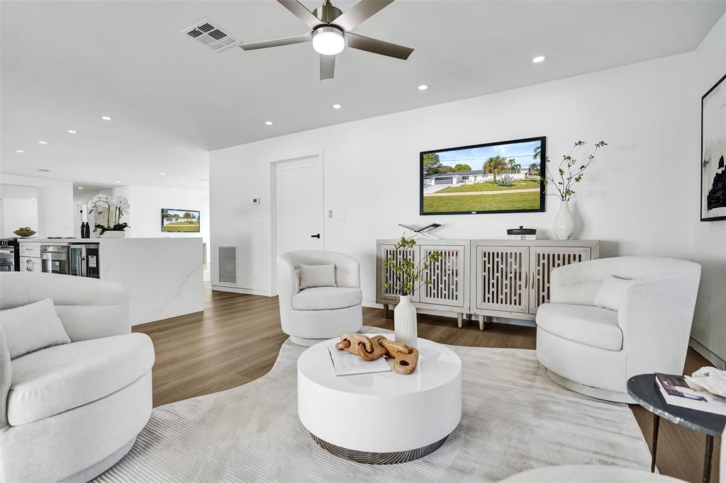 699 Northeast 70th Street Boca Raton, FL 33487 - Photo 28 of 60 a living room with furniture and a flat screen tv