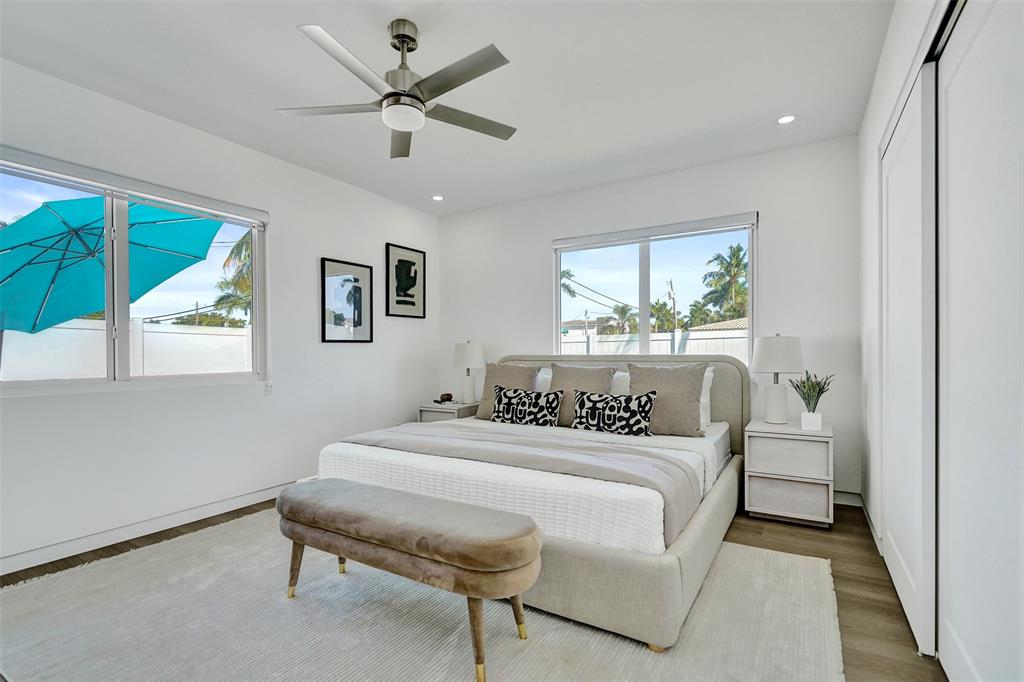 699 Northeast 70th Street Boca Raton, FL 33487 - Photo 32 of 60 a bedroom with a bed and a table