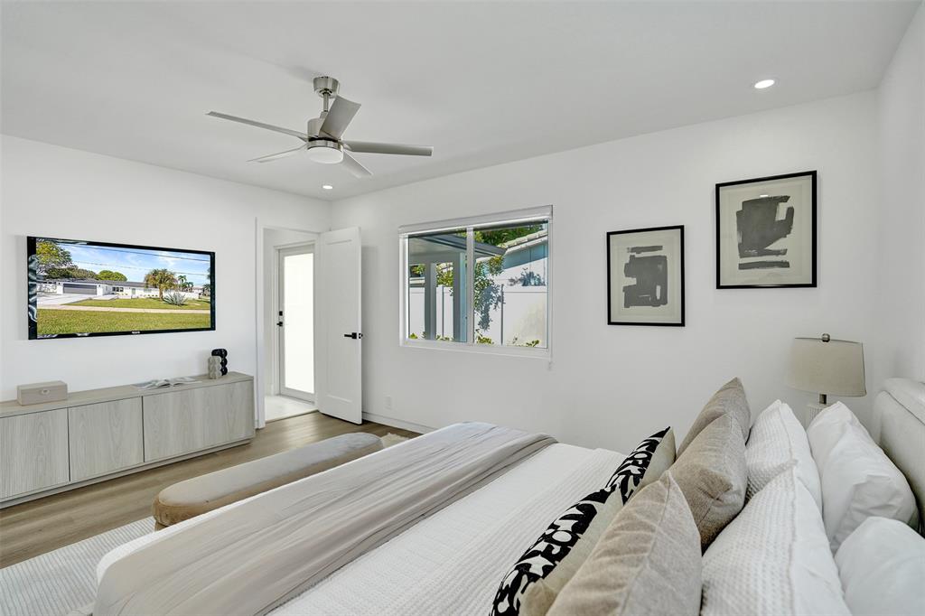 699 Northeast 70th Street Boca Raton, FL 33487 - Photo 33 of 60 a bedroom with a bed and a flat screen tv