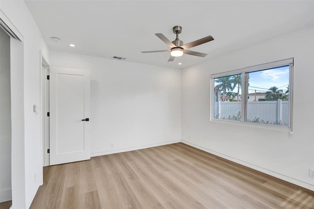 699 Northeast 70th Street Boca Raton, FL 33487 - Photo 37 of 60 a view of empty room with wooden floor and fan