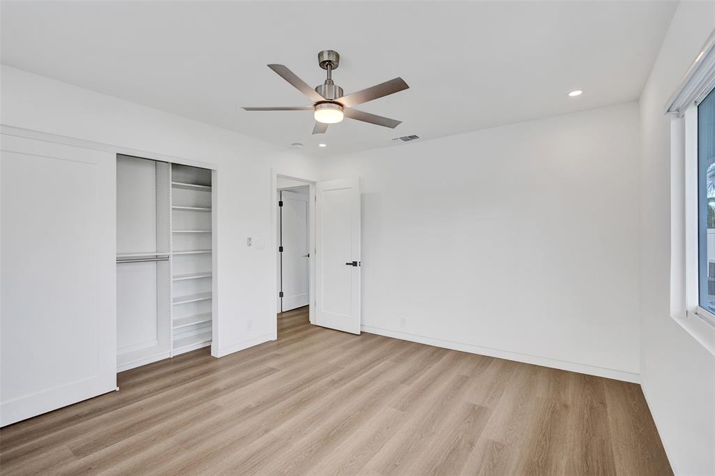 699 Northeast 70th Street Boca Raton, FL 33487 - Photo 38 of 60 wooden floor in an empty room with a window
