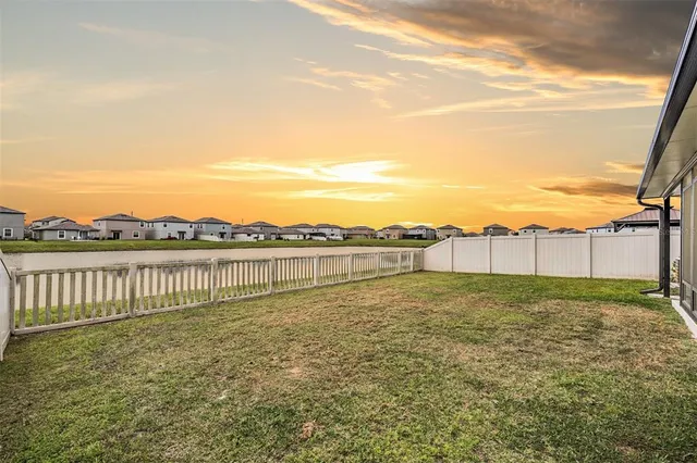 a view of a house with a backyard