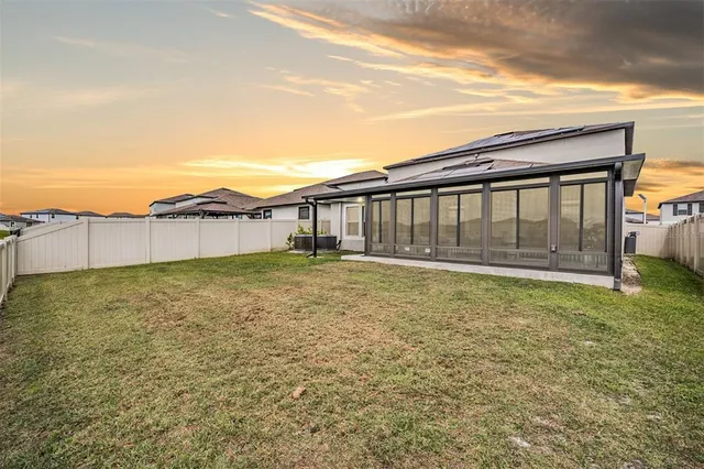 a living room with a floor to ceiling window and floor to ceiling window