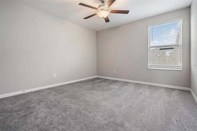 a view of a livingroom with workspace and a window