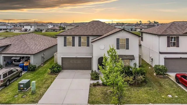 front view of a brick house with a small yard