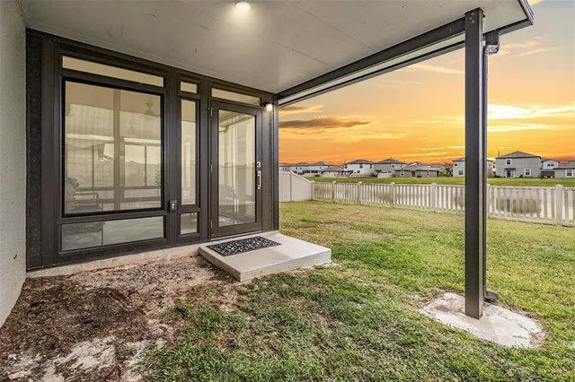 a aerial view of a house with a yard and potted plants