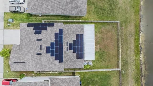 a large kitchen with stainless steel appliances granite countertop a sink and dishwasher a stove top oven with white cabinets