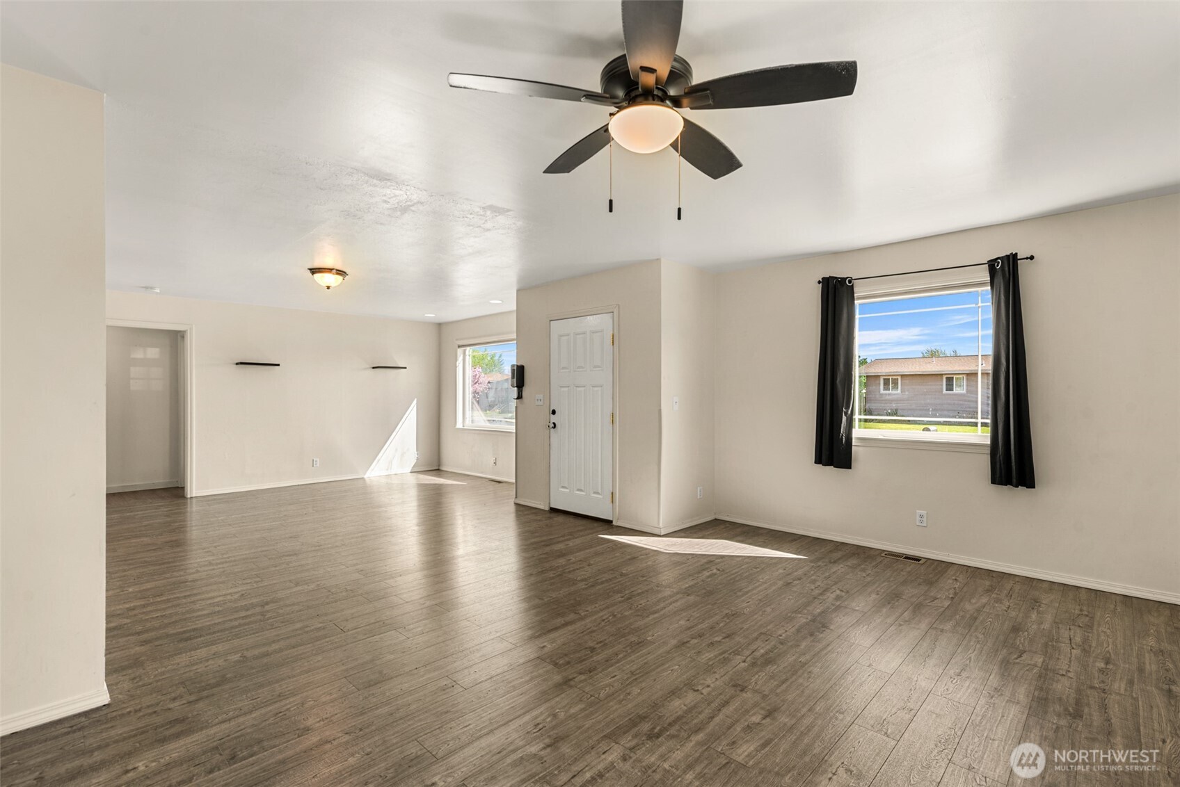 523 K Street Southwest Quincy, WA 98848 - Photo 7 of 35 a view of an empty room with window and wooden floor