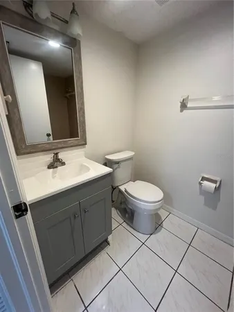 a bathroom with a sink mirror vanity and toilet
