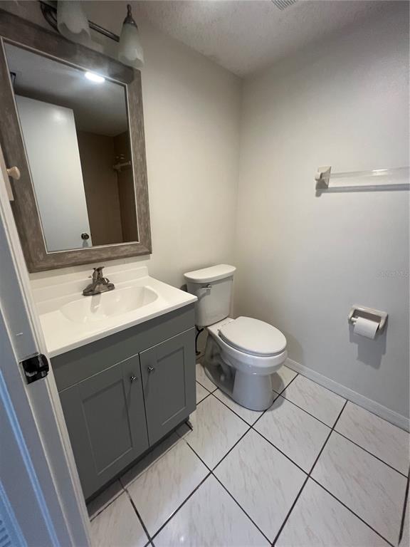 1330 Rio De Janeiro Avenue, Unit 5 Punta Gorda, FL 33983 - Photo 11 of 17 a bathroom with a sink mirror vanity and toilet