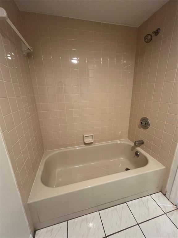1330 Rio De Janeiro Avenue, Unit 5 Punta Gorda, FL 33983 - Photo 12 of 17 a white bath tub sitting next to a shower