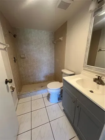 a bathroom with a sink a toilet and a mirror