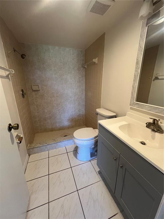 1330 Rio De Janeiro Avenue, Unit 5 Punta Gorda, FL 33983 - Photo 9 of 17 a bathroom with a sink a toilet and a mirror