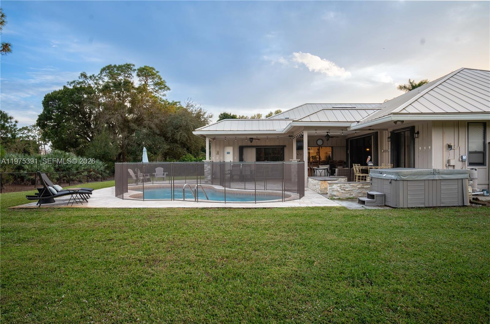 1872 Southeast Colony Way Jupiter, FL 33478 - Photo 9 of 26 a view of a house with a swimming pool and porch