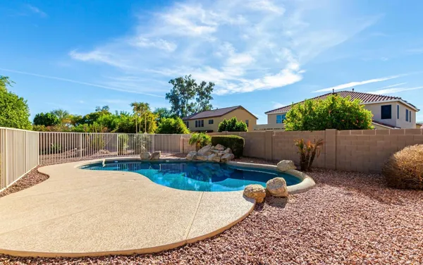 a swimming pool with barbeque oven in front of it