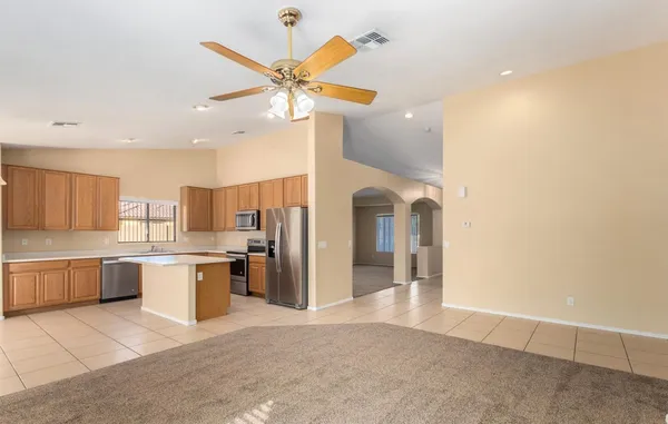 a view of a kitchen with a sink and a refrigerator