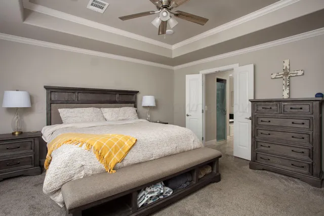 a bedroom with a bed and a dresser