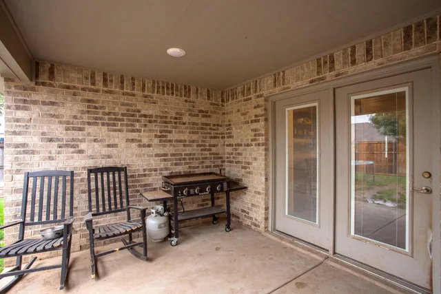 a front view of a house with patio and garden