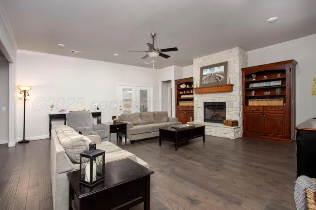 a living room with furniture fireplace and wooden floor