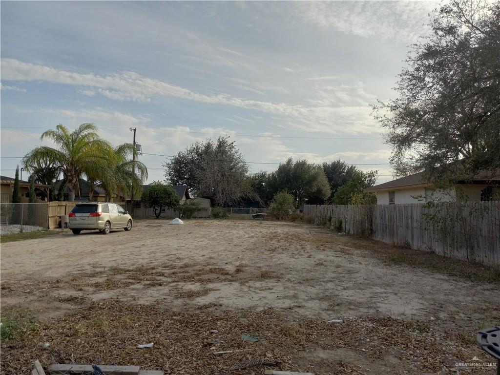 a view of backyard with a car parked
