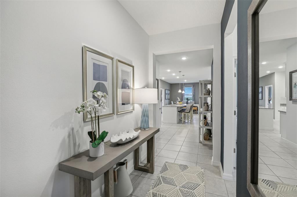9600 Starling Loop Leesburg, FL 34788 - Photo 2 of 36 a dining room with furniture and a potted plant